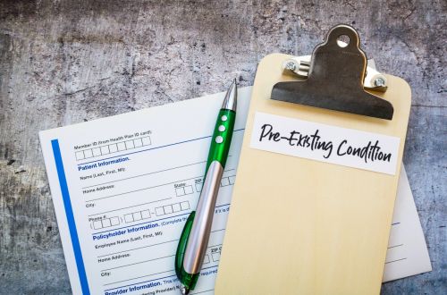 Pre-Existing Condition on clipboard with pills and money and forms - pre-existing condition and workers comp concept