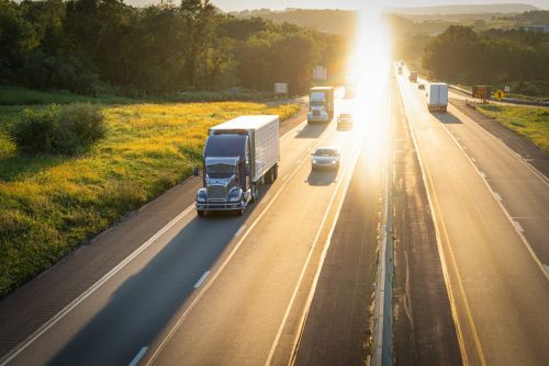 Highway commercial freight semi trucks view from above. Visual concept for personal injury blog discussing semi truck accidents.