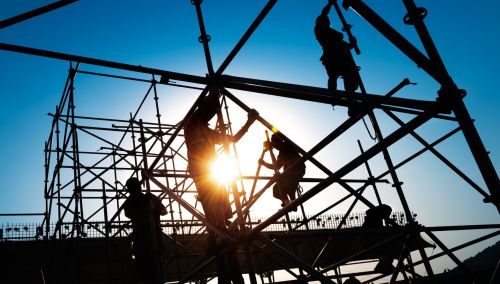 Group of construction workers working on scaffolding. Visual concept for a workers' compensation blog discussing third party liability.
