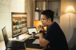 Man smiling wearing glasses working with computer laptop. concept work from home. Remote workers.