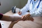 A doctor examines a woman’s injured arm — a visual concept for a personal injury blog on the SOL for Washington. Learn the statute of limitations deadlines and how to protect your right to file a claim.